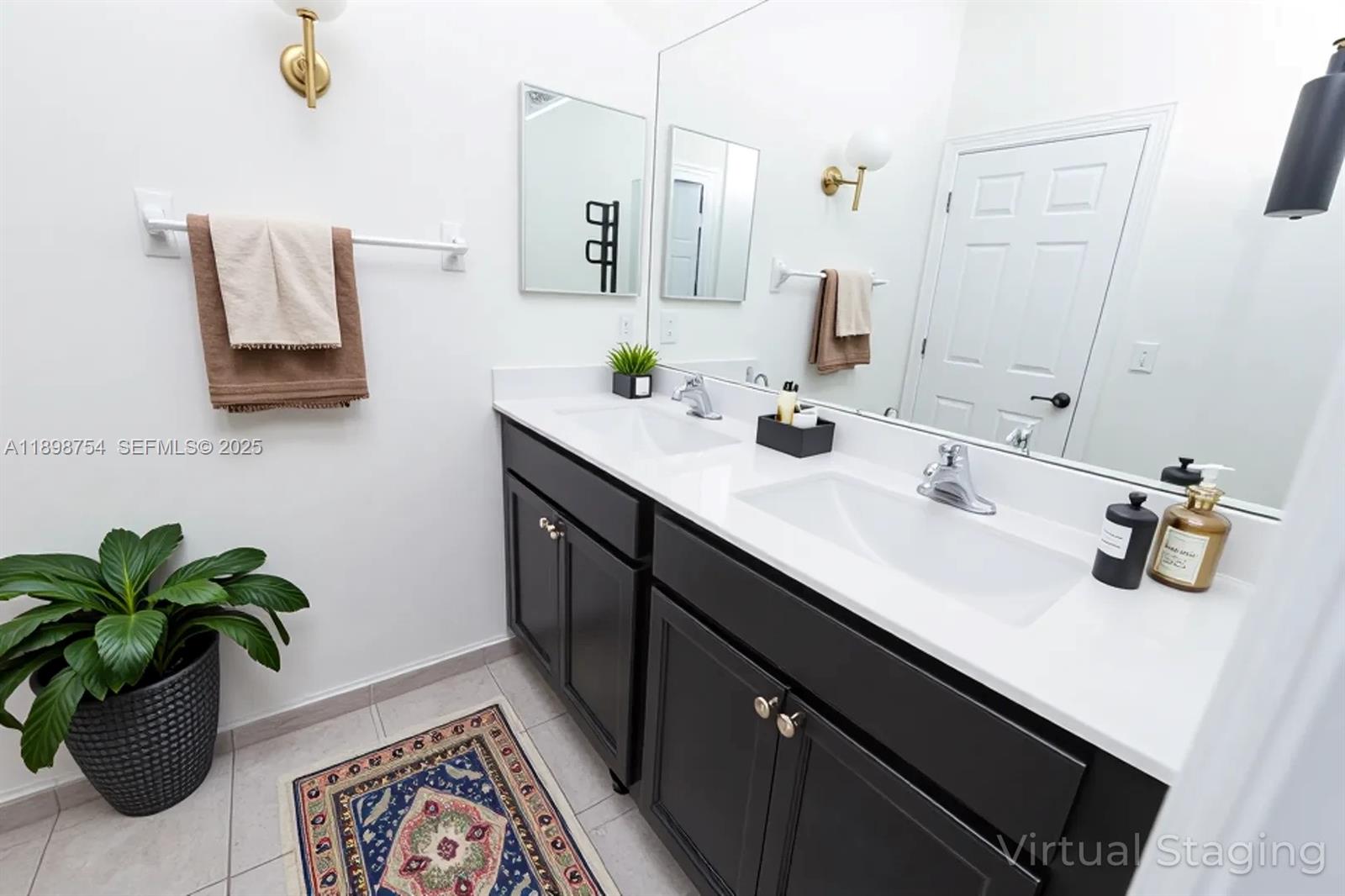 3412 West 103rd Terrace Hialeah, FL 33018 - Photo 33 of 44 a bathroom with a sink a mirror and potted plant
