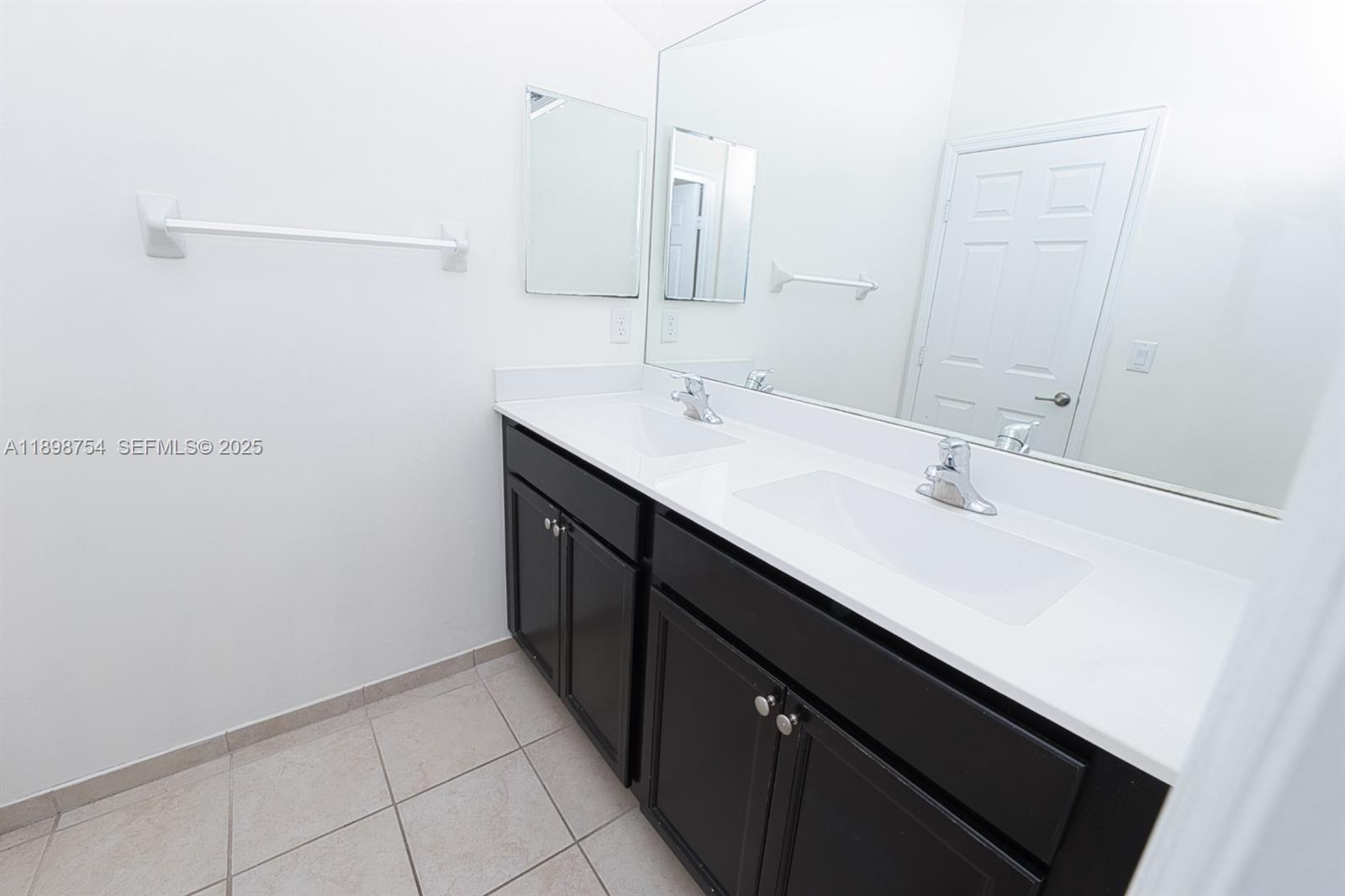 3412 West 103rd Terrace Hialeah, FL 33018 - Photo 34 of 44 a bathroom with a sink and a mirror