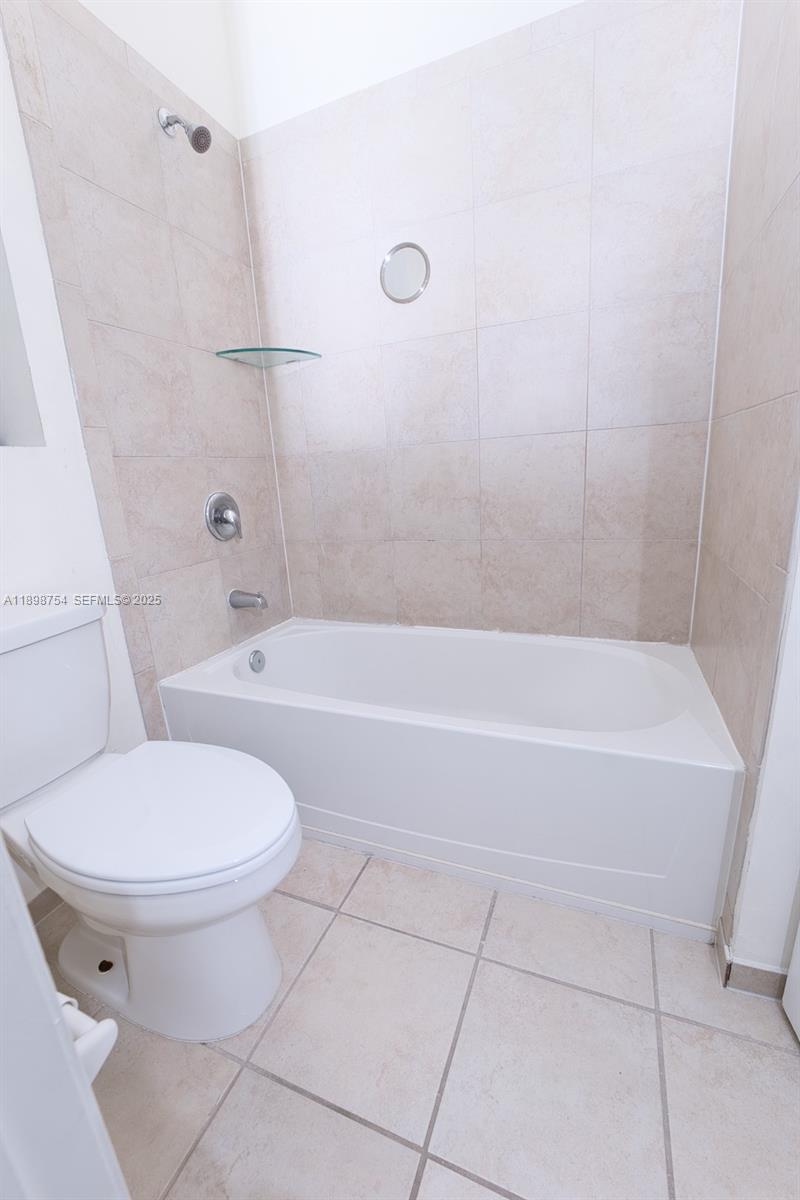 3412 West 103rd Terrace Hialeah, FL 33018 - Photo 35 of 44 a bathroom with a toilet and a bath tub