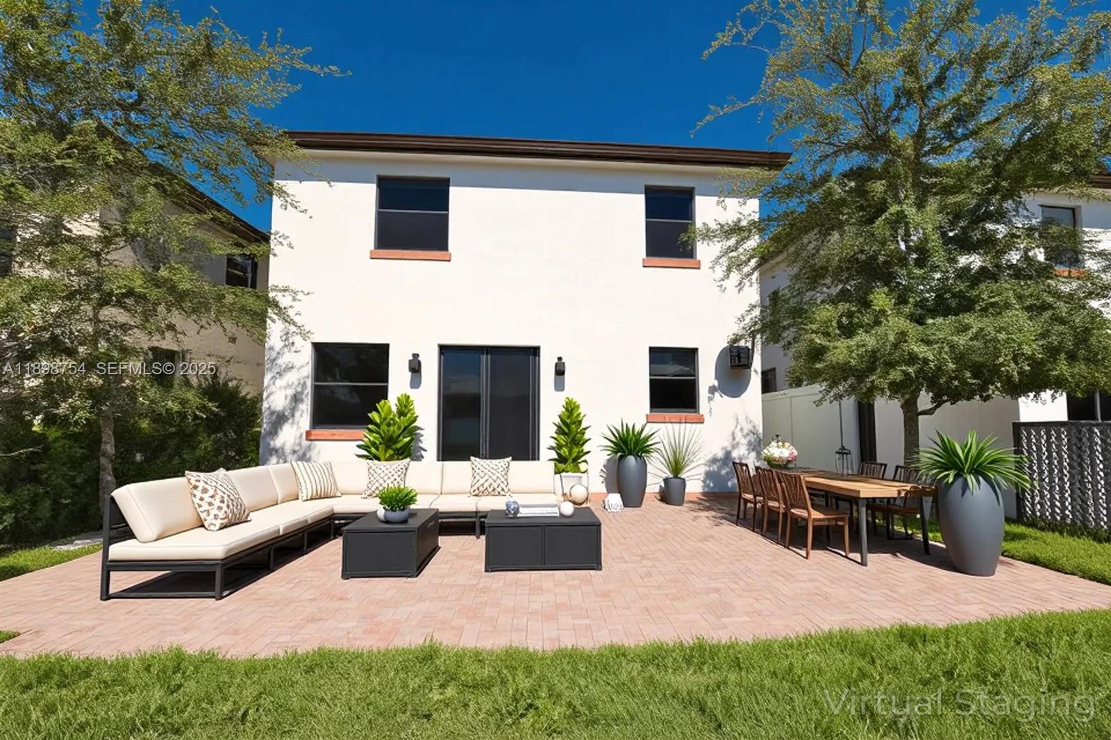 3412 West 103rd Terrace Hialeah, FL 33018 - Photo 40 of 44 a view of a patio with couches chairs and a fire pit