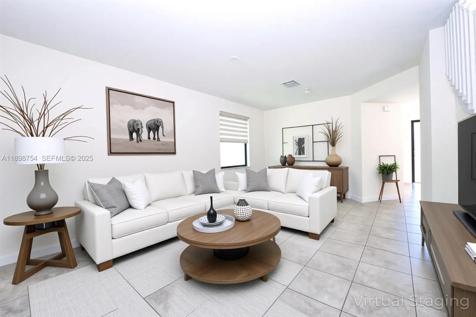 3412 West 103rd Terrace Hialeah, FL 33018 - Photo 5 of 44 a living room with furniture and a painting on the wall