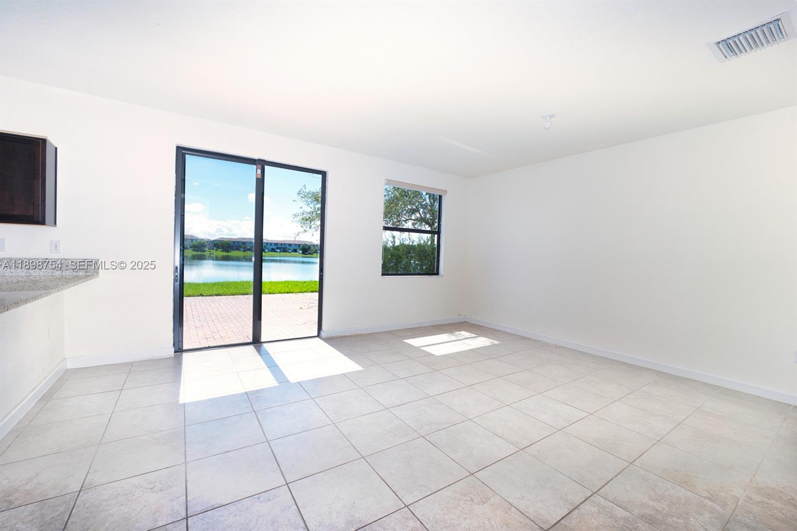 3412 West 103rd Terrace Hialeah, FL 33018 - Photo 8 of 44 a view of an empty room with a window