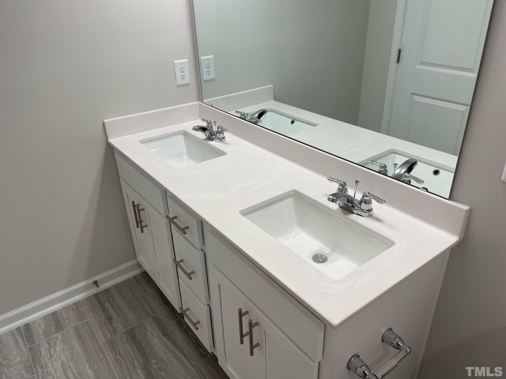 4914 Oolite Street, Unit 15 Raleigh, NC 27610 - Photo 13 of 21 a bathroom with a sink and a mirror