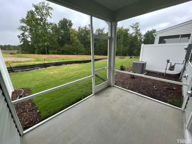 a view of a backyard and floor to ceiling window