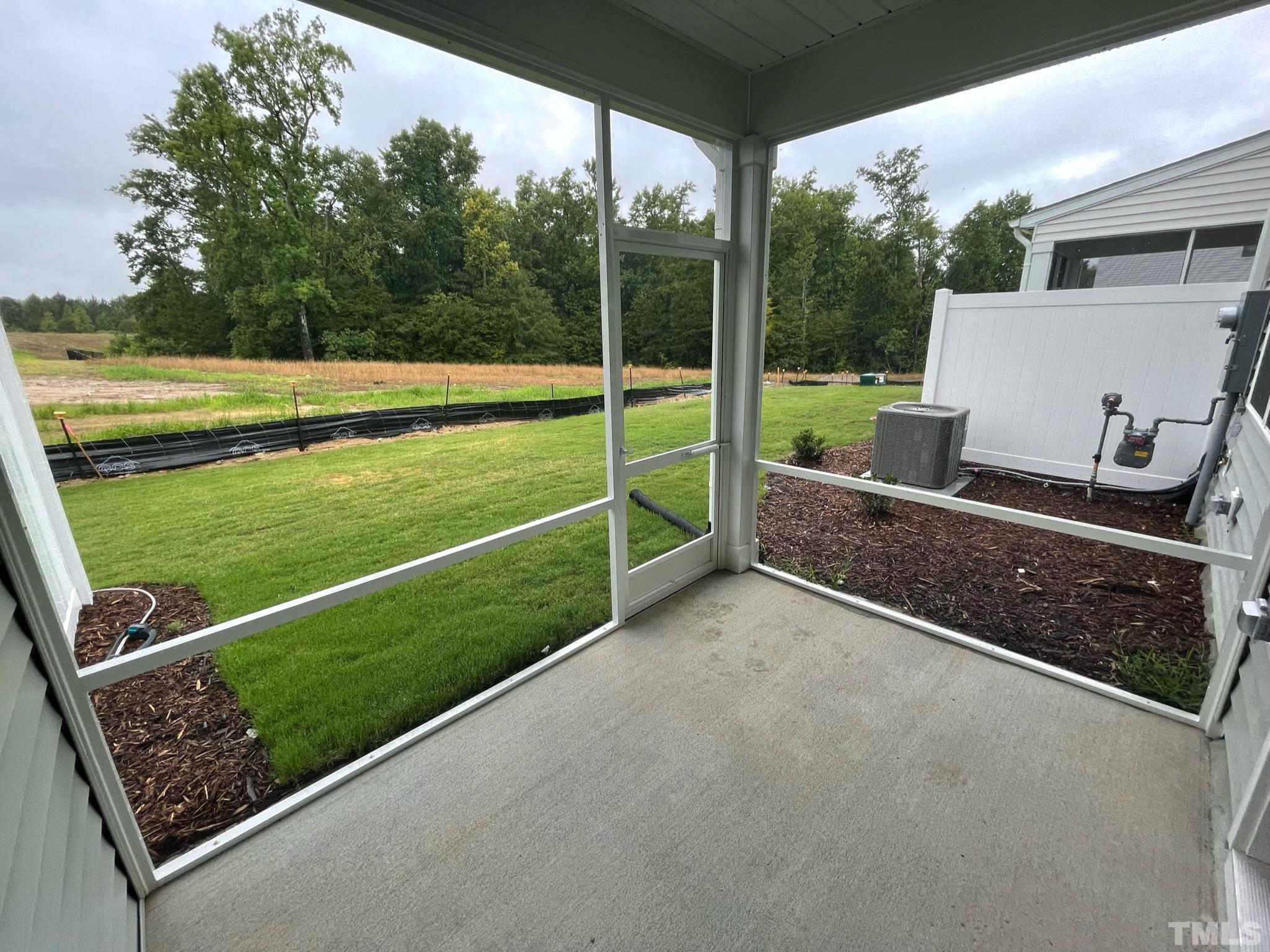 4914 Oolite Street, Unit 15 Raleigh, NC 27610 - Photo 17 of 21 a view of a backyard and floor to ceiling window