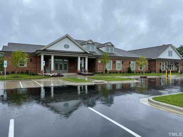 a front view of a house with a yard table and chairs