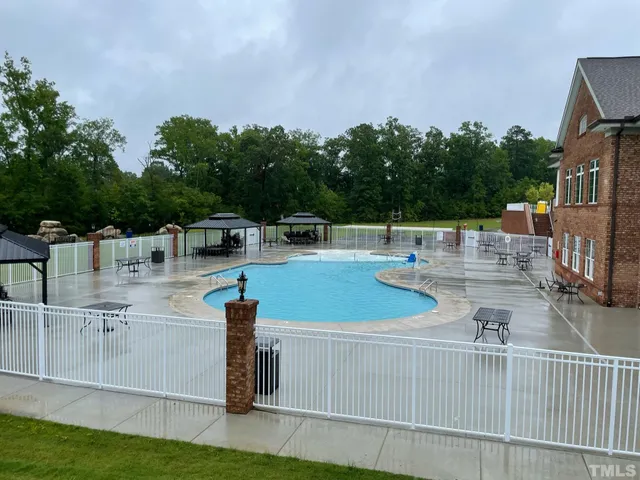 swimming pool view with a seating space
