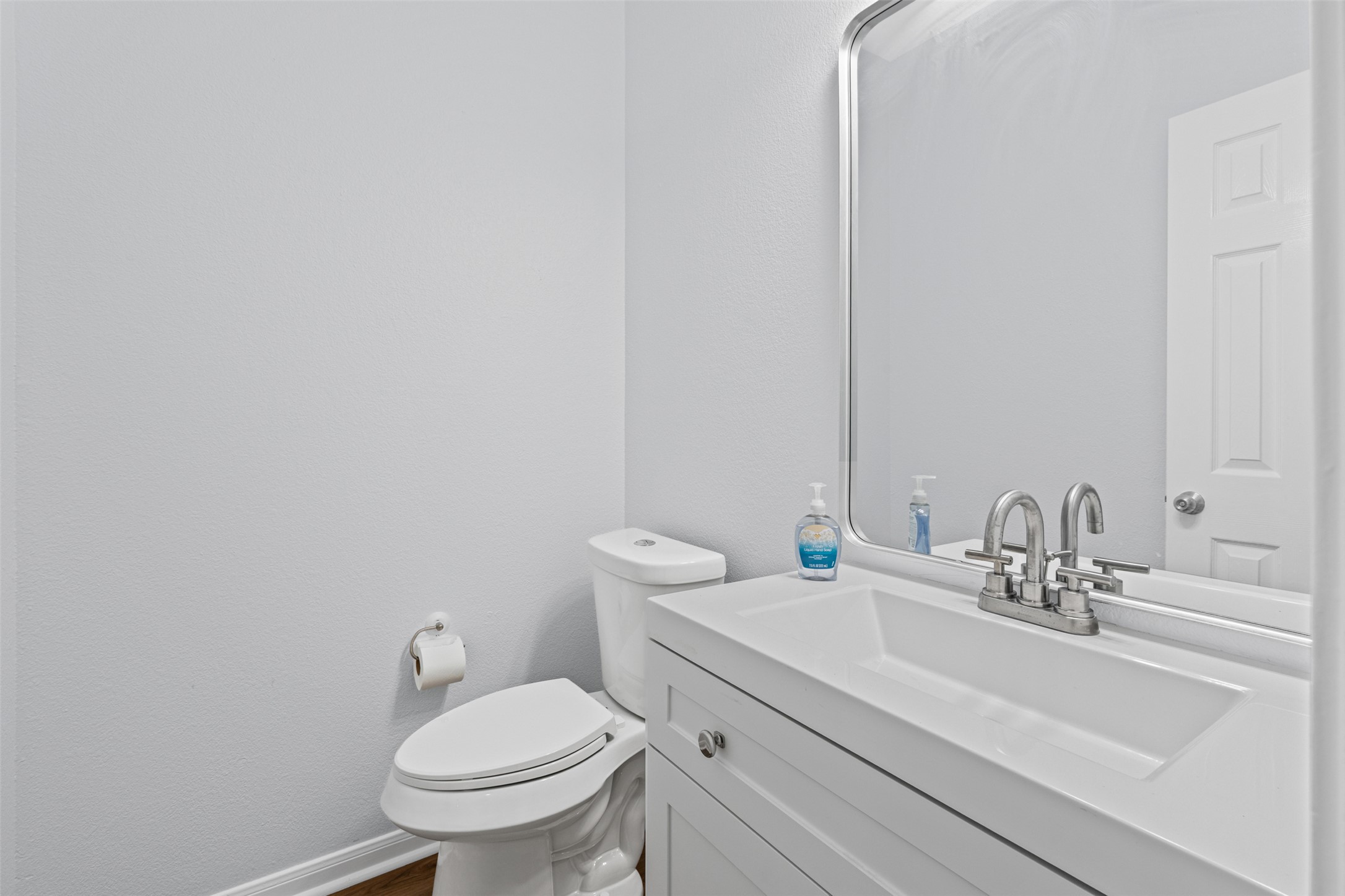 243 Engineers Pass Jarrell, TX 76537 - Photo 17 of 40 Bathroom featuring a white vanity with integrated sink, chrome faucet, and a wall-mounted mirror