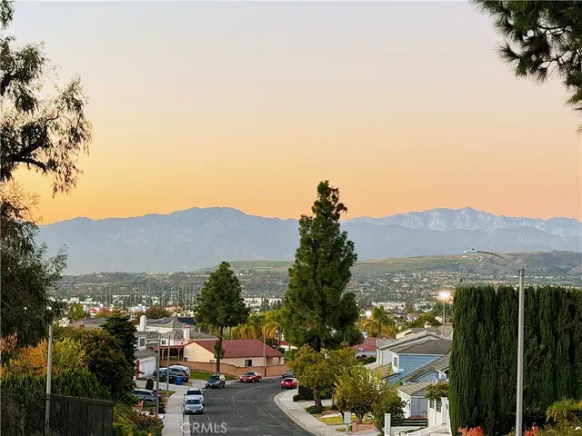 a view of a city street and a mountain
