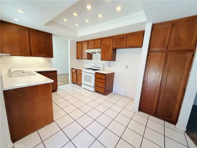 a kitchen with stainless steel appliances a sink stove and cabinets
