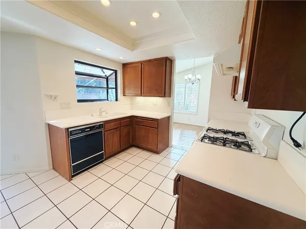 a kitchen with stainless steel appliances a stove a sink and a refrigerator