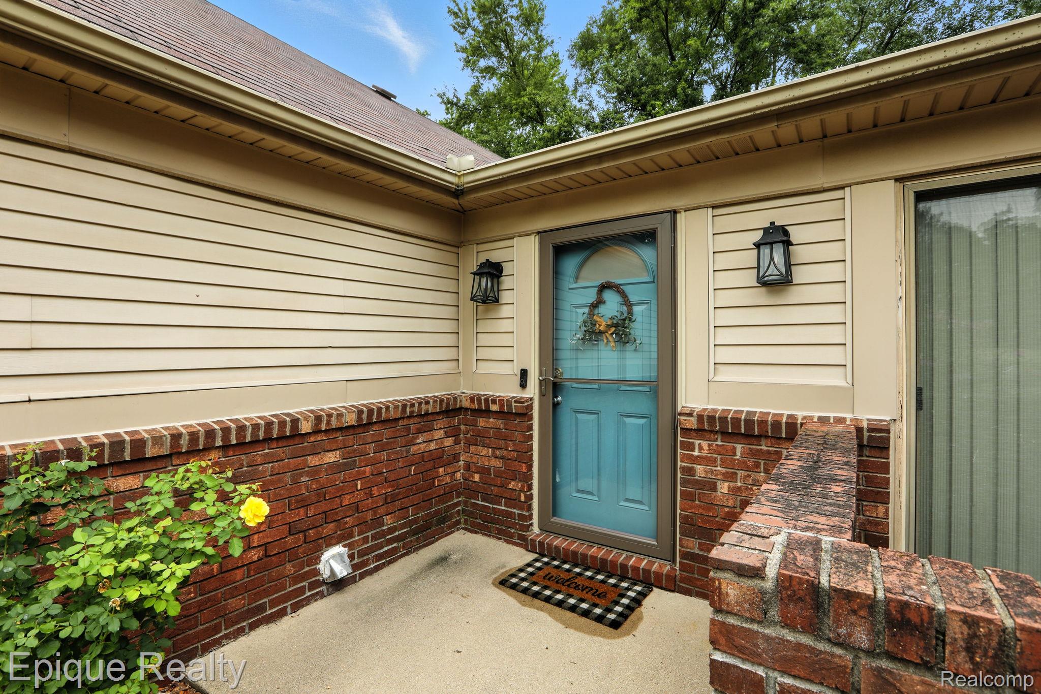 8529 22 Mile Road Utica, MI 48317 - Photo 10 of 40 Doorway to property with roof with shingles and brick siding