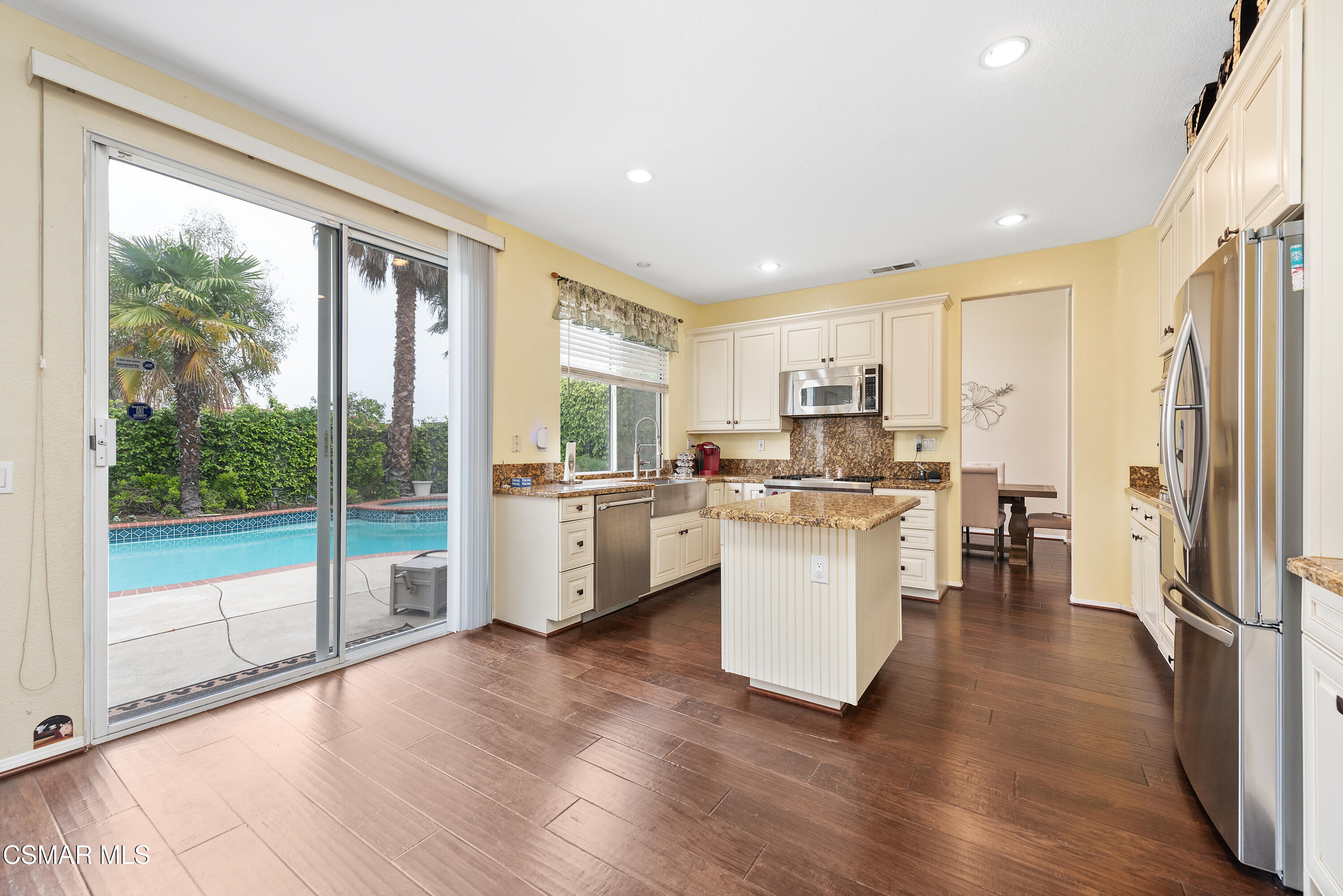 295 Cliffwood Drive Simi Valley, CA 93065 - Photo 11 of 49 a kitchen with white cabinets and stainless steel appliances