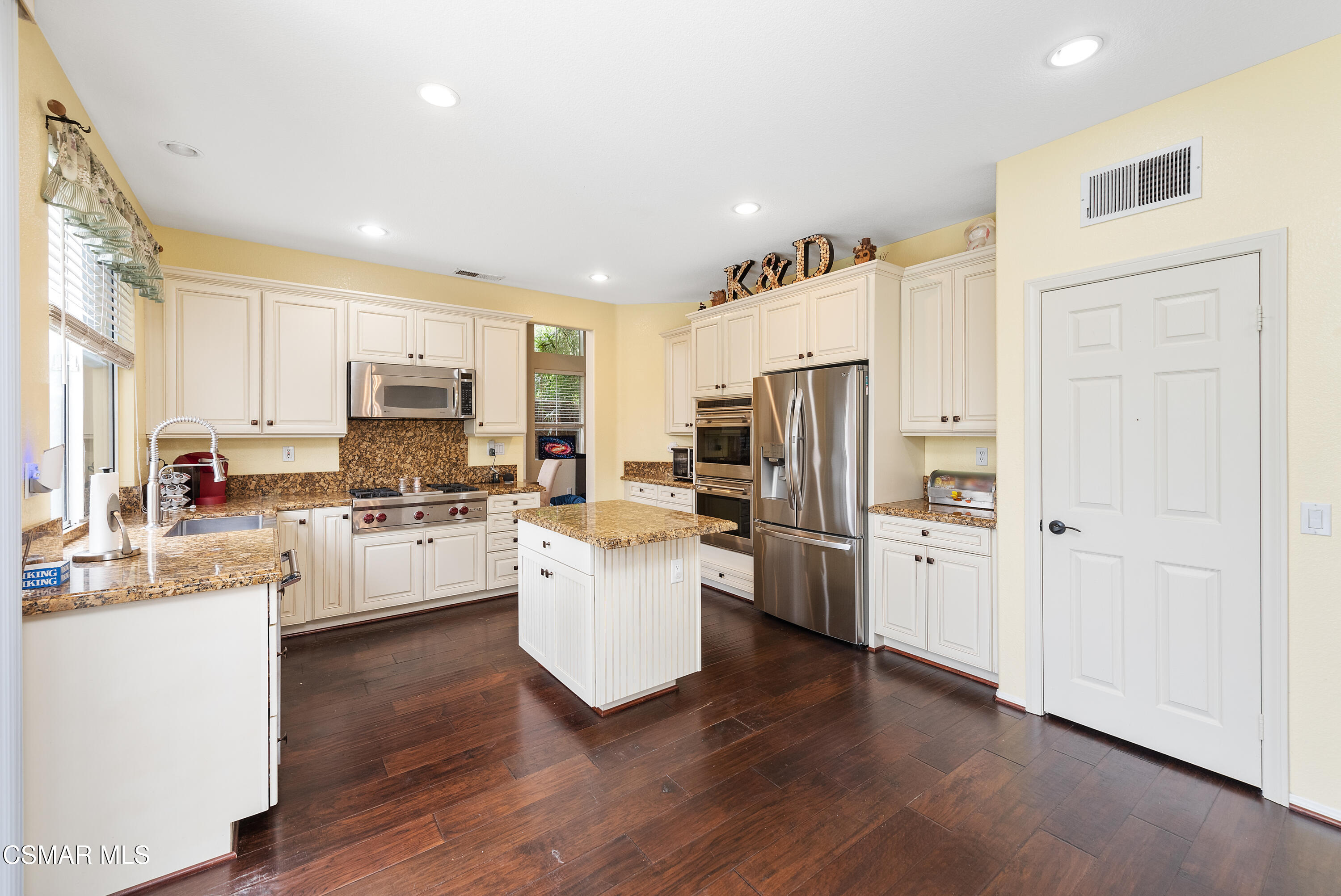 295 Cliffwood Drive Simi Valley, CA 93065 - Photo 12 of 49 a kitchen with stainless steel appliances a refrigerator cabinets and wooden floor
