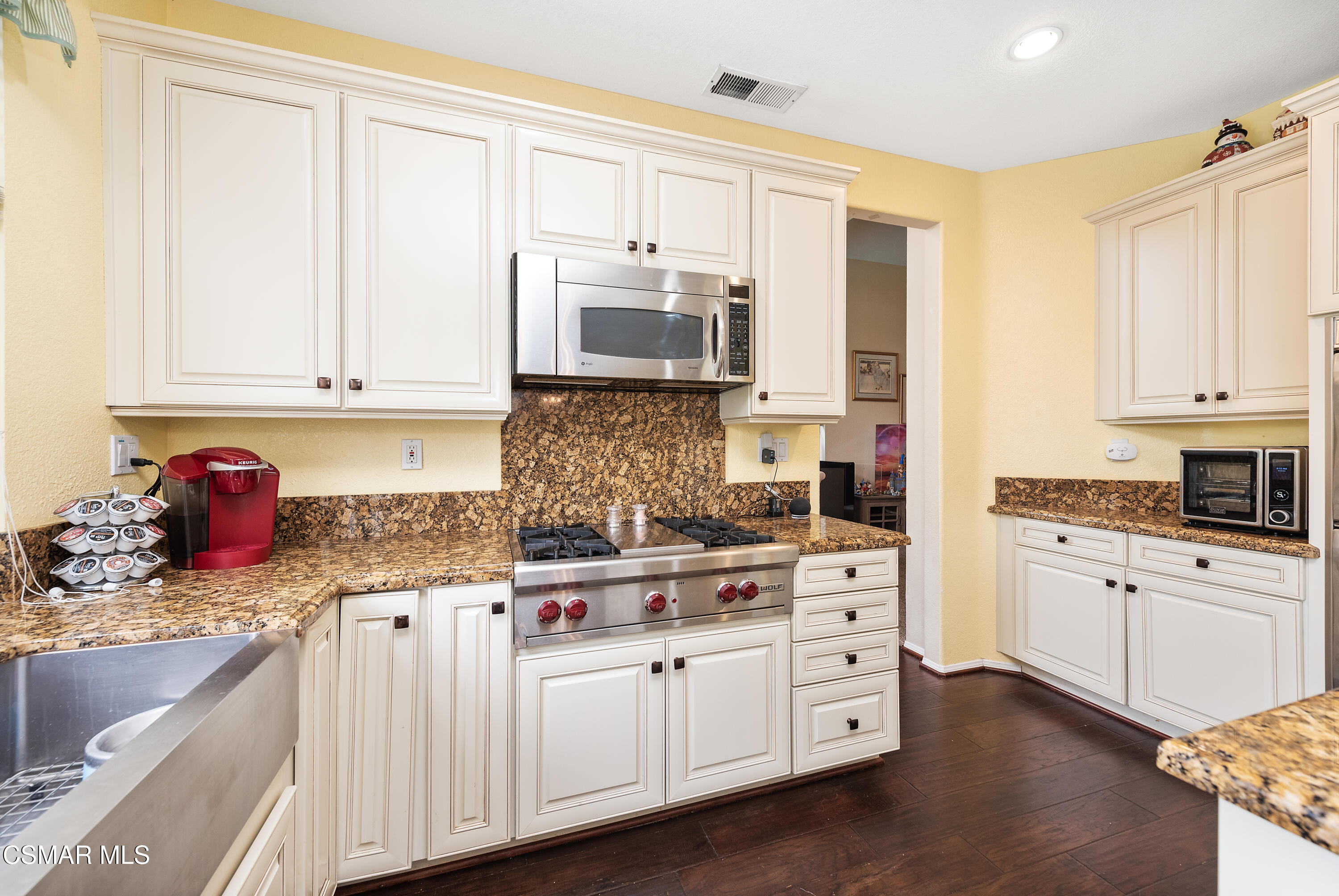 295 Cliffwood Drive Simi Valley, CA 93065 - Photo 17 of 49 a kitchen with stainless steel appliances granite countertop a stove sink and cabinets