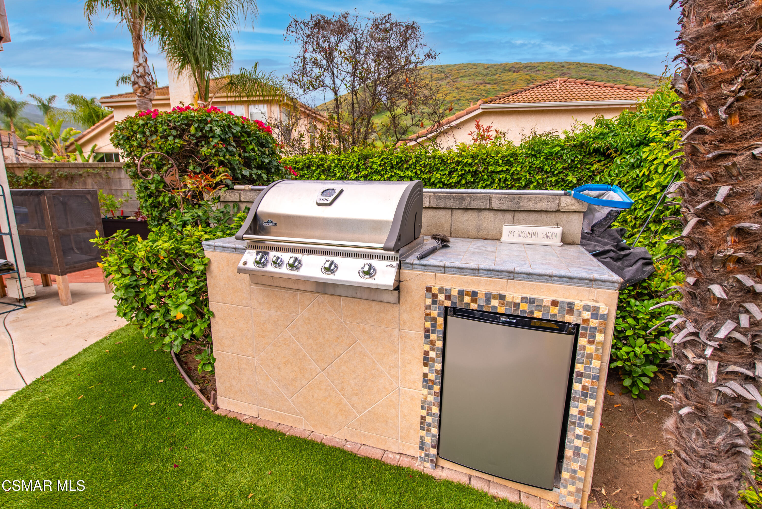 295 Cliffwood Drive Simi Valley, CA 93065 - Photo 42 of 49 a view of a backyard with plants and palm tree