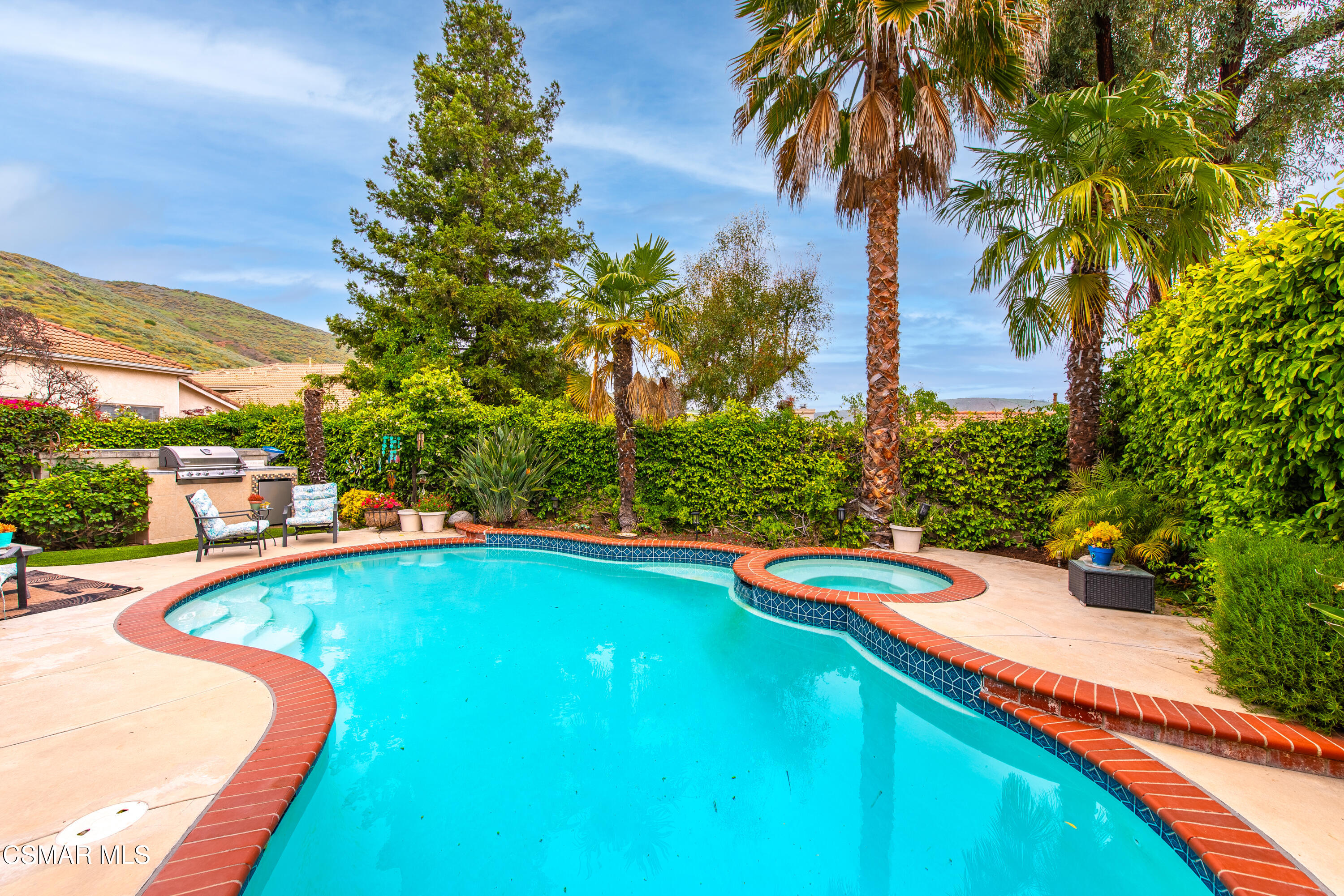 295 Cliffwood Drive Simi Valley, CA 93065 - Photo 46 of 49 a view of a swimming pool with a yard and palm trees