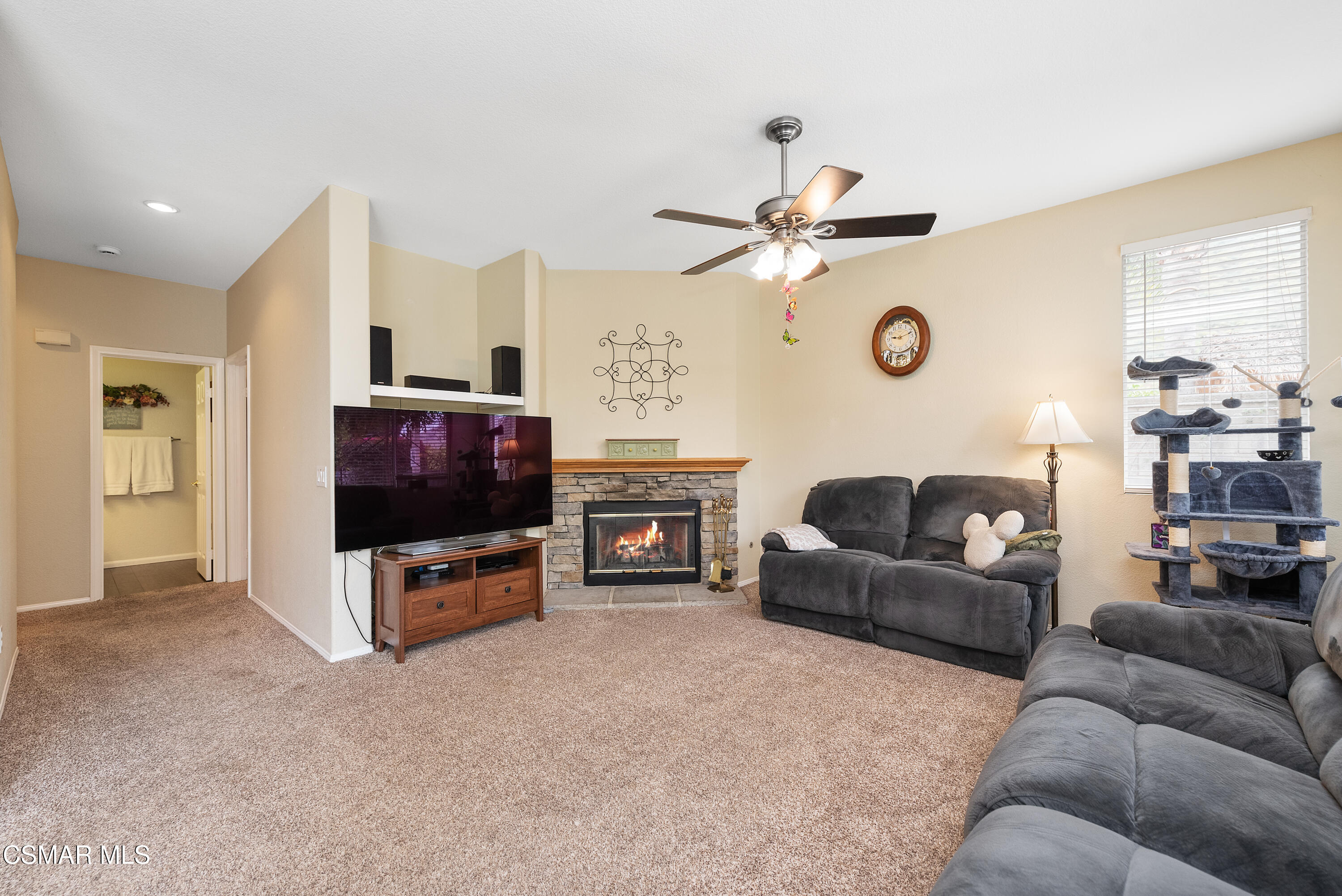 295 Cliffwood Drive Simi Valley, CA 93065 - Photo 8 of 49 a living room with furniture a flat screen tv and a clock