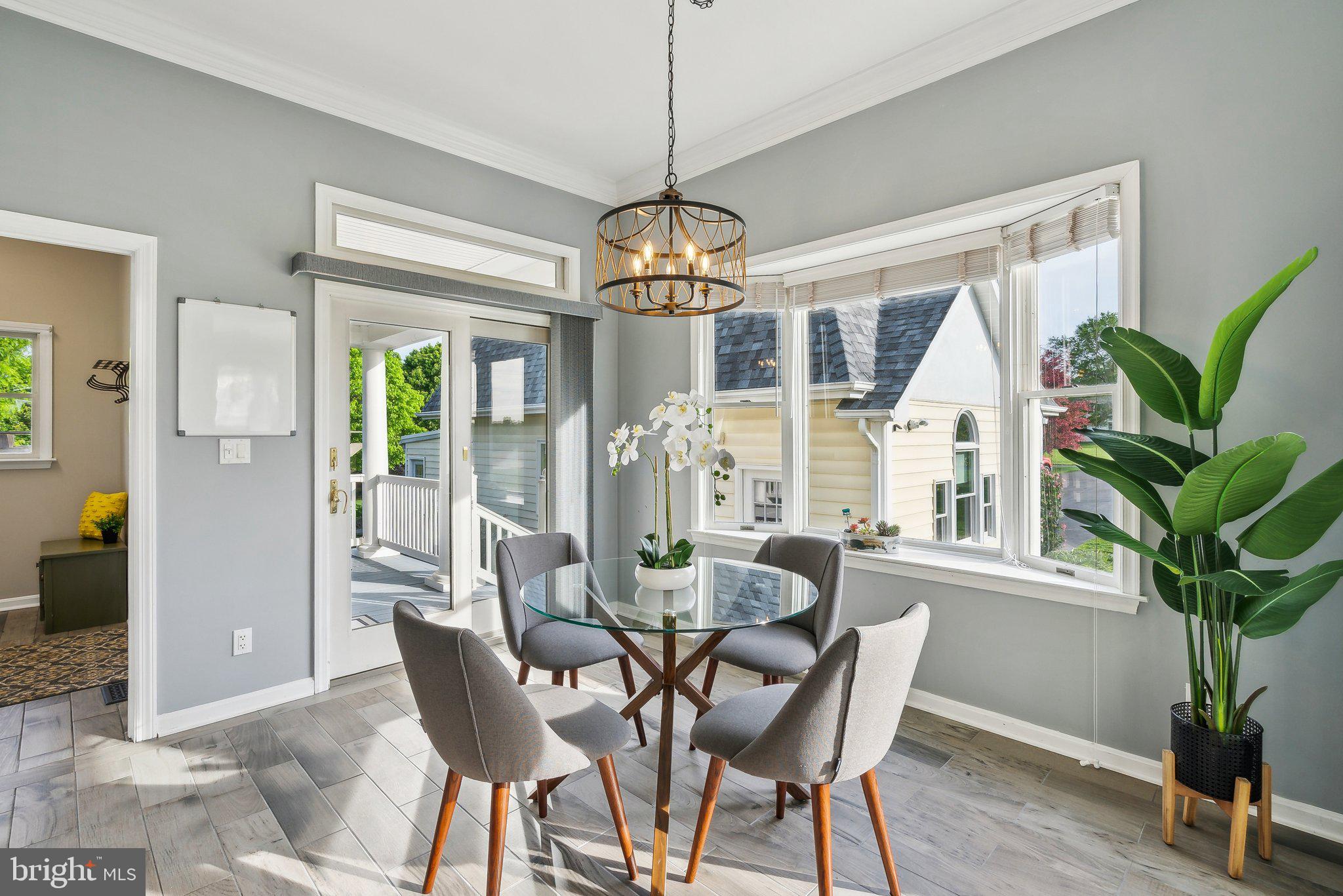 20437 Peach Tree Road Dickerson, MD 20842 - Photo 11 of 53 a dining room with furniture potted plants and wooden floor