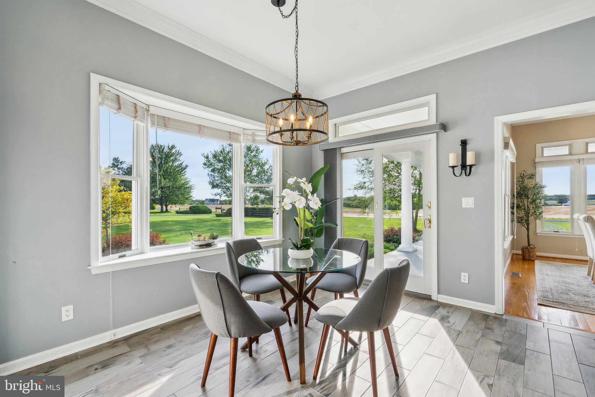 20437 Peach Tree Road Dickerson, MD 20842 - Photo 12 of 53 a dining room with furniture large windows and a chandelier