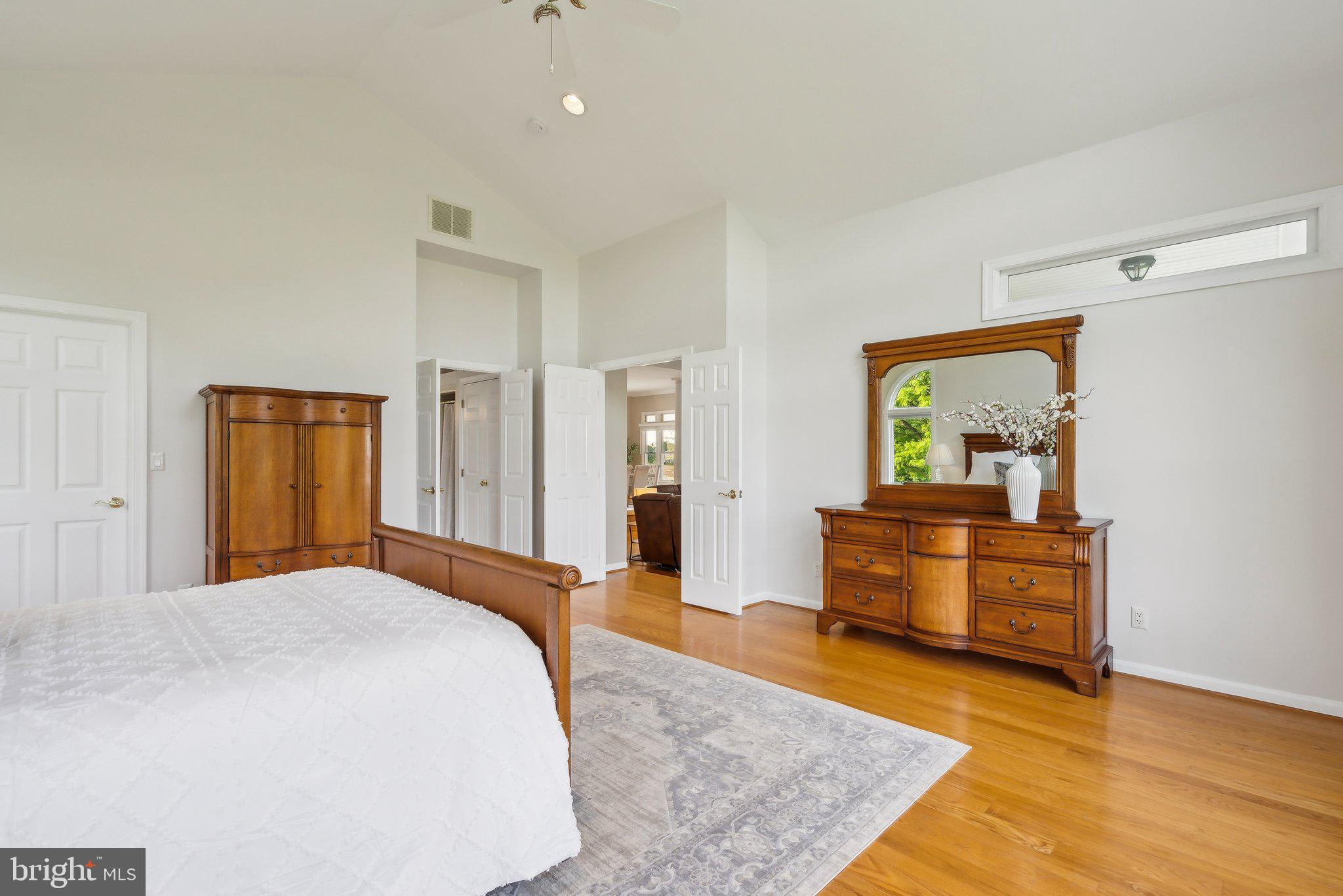 20437 Peach Tree Road Dickerson, MD 20842 - Photo 22 of 53 a spacious bedroom with a bed and wooden floor