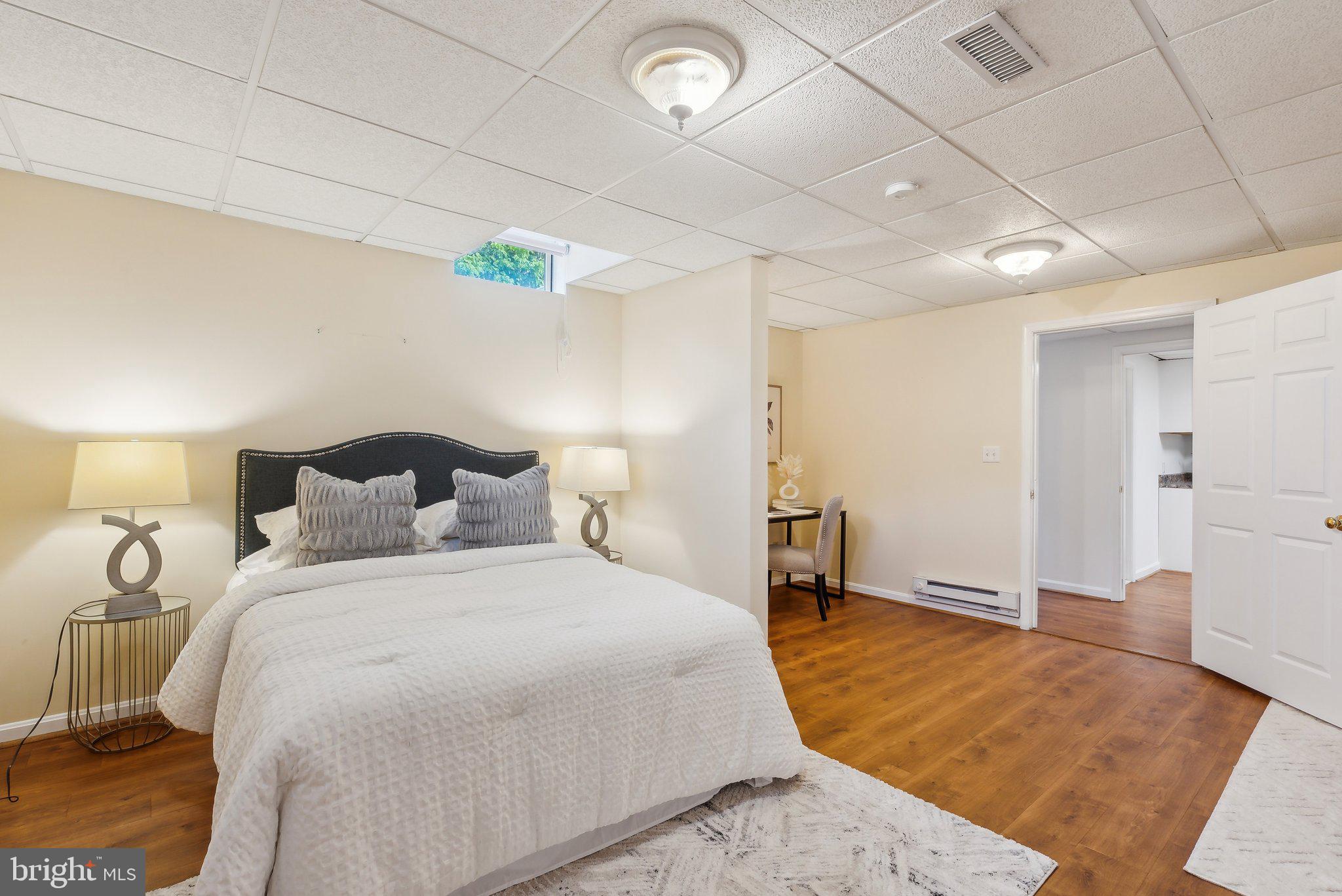 20437 Peach Tree Road Dickerson, MD 20842 - Photo 31 of 53 a large bedroom with a bed and wooden floor