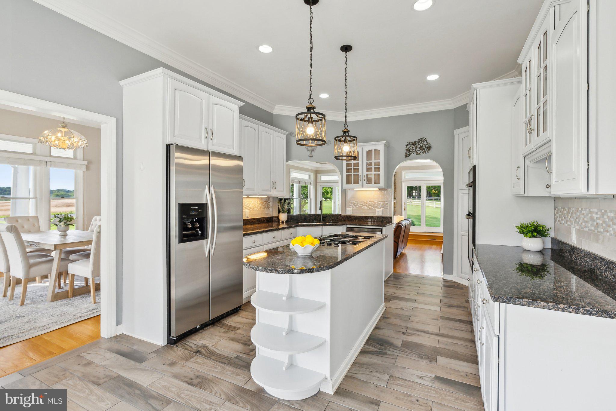 20437 Peach Tree Road Dickerson, MD 20842 - Photo 8 of 53 a large kitchen with stainless steel appliances granite countertop a stove a refrigerator a sink a oven and white cabinets with wooden floor