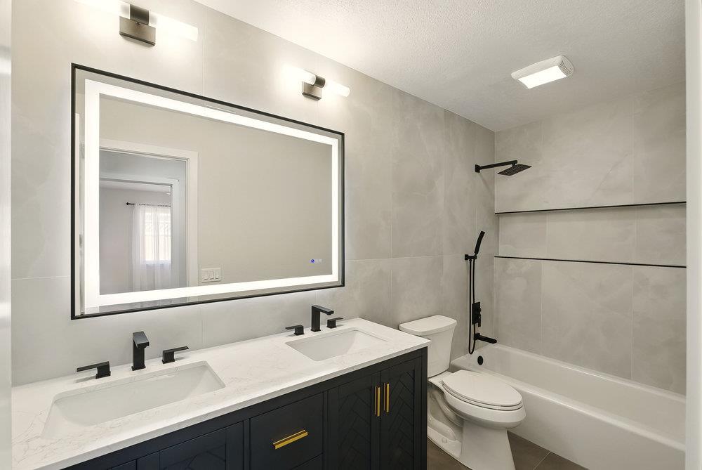 1180 Peterson Drive Gilroy, CA 95020 - Photo 30 of 45 a bathroom with a double vanity sink toilet mirror and shower