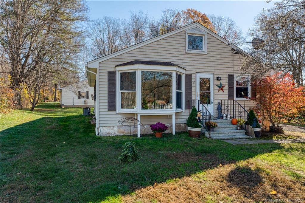 a front view of house with yard and green space