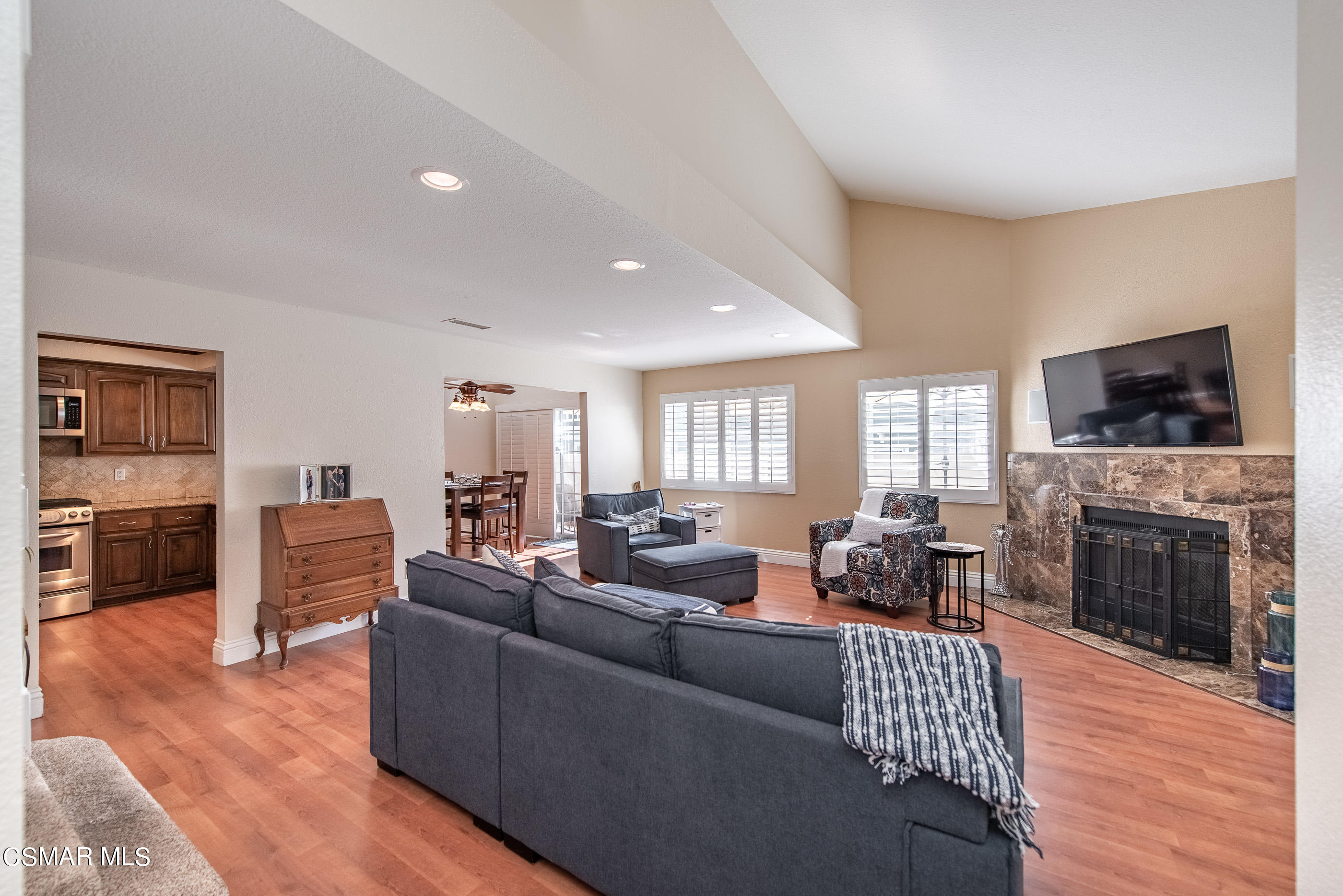 1940 Rory Lane, Unit 3 Simi Valley, CA 93063 - Photo 3 of 33 a living room with furniture a flat screen tv and a fireplace