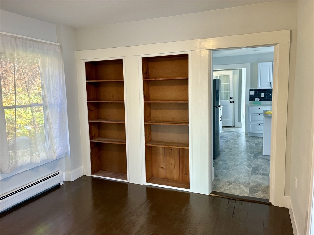 140 Mechanic Street Orange, MA 01364 - Photo 6 of 39 a view of an empty room with wooden floor and a window