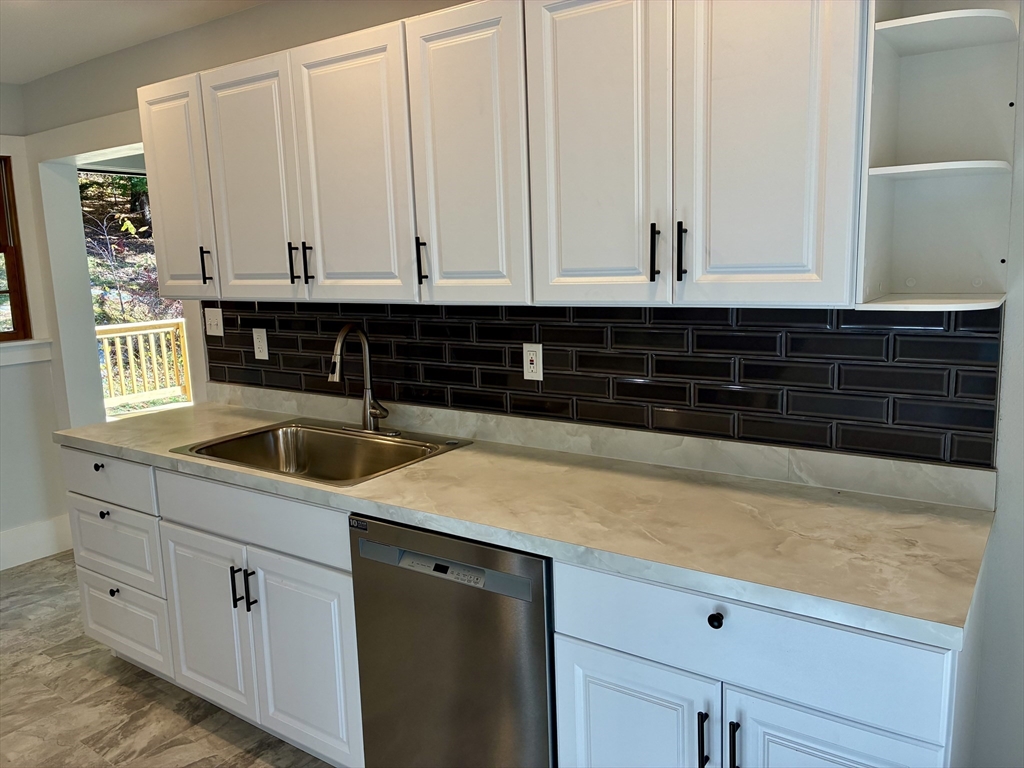 140 Mechanic Street Orange, MA 01364 - Photo 7 of 39 a kitchen with granite countertop white cabinets and sink