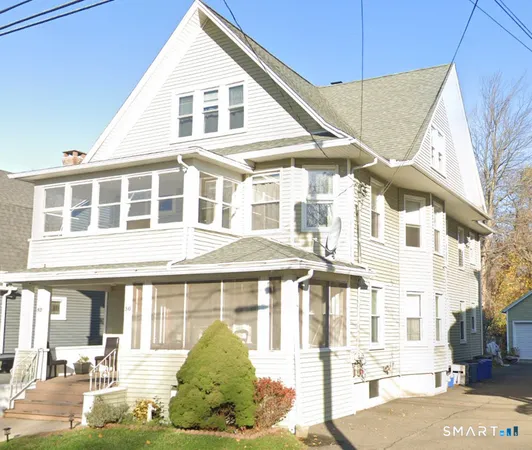 a view of a white building among the street