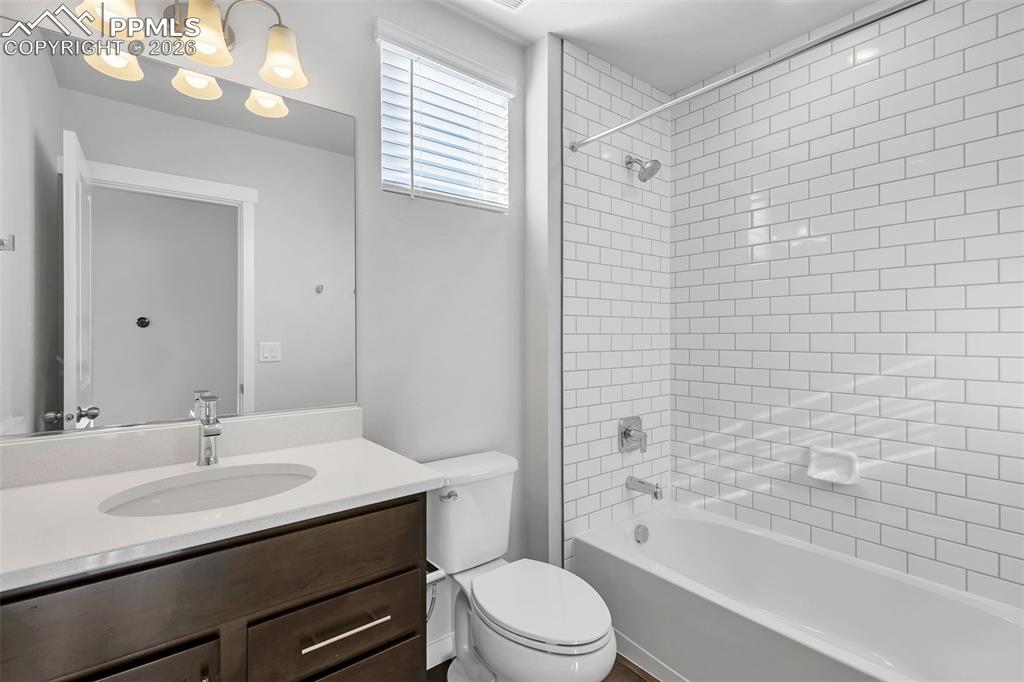 13641 Frost Bitten Grove Colorado Springs, CO 80921 - Photo 11 of 13 a bathroom with a sink a toilet and shower