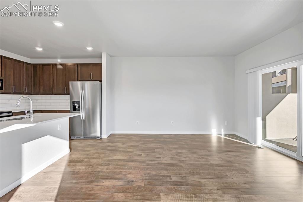 13641 Frost Bitten Grove Colorado Springs, CO 80921 - Photo 10 of 13 a kitchen with stainless steel appliances granite countertop a refrigerator sink and cabinets