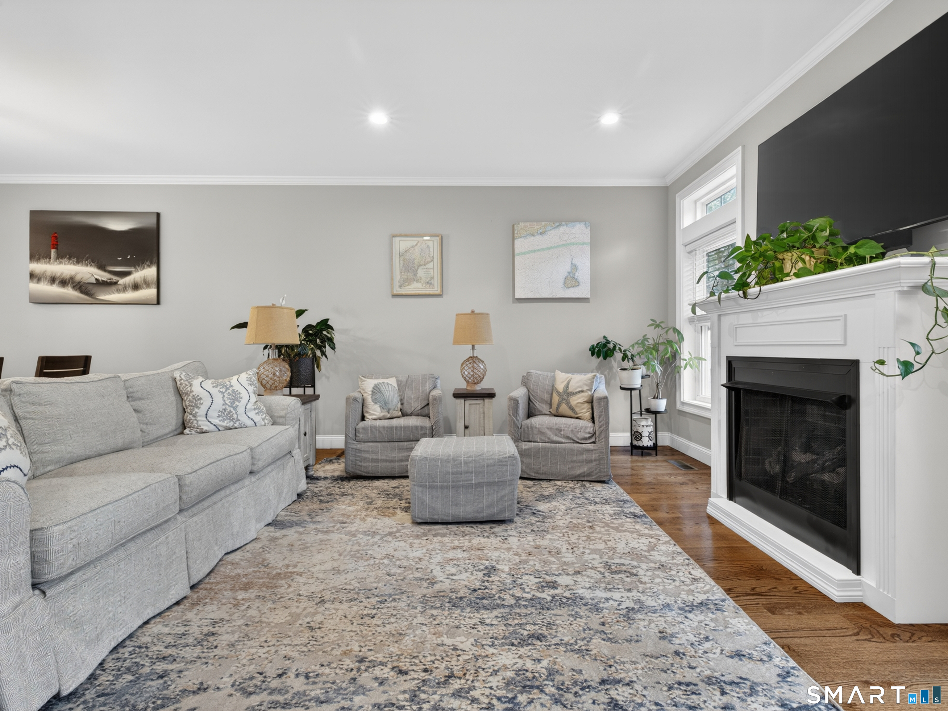 34 Village Crossing, Unit 34 Niantic, CT 06357 - Photo 7 of 38 a living room with furniture a fireplace and a flat screen tv
