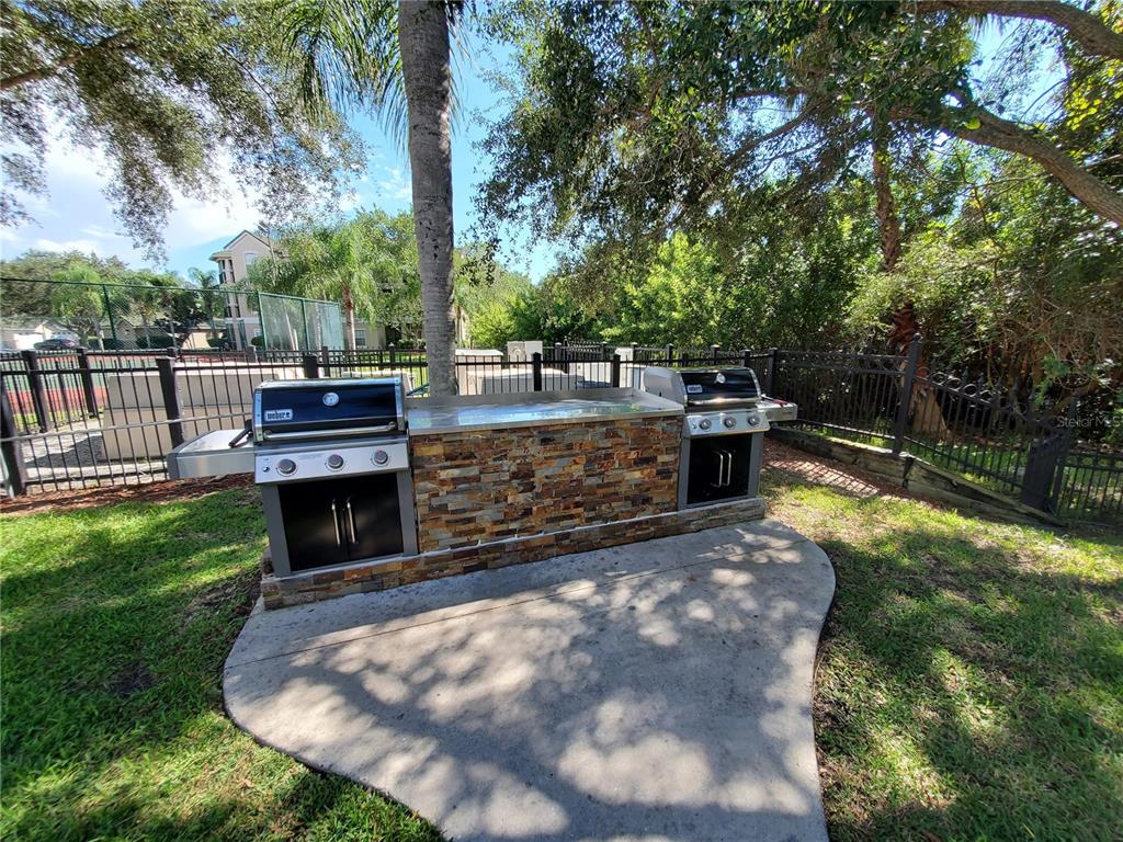 5174 Northridge Road, Unit 209 Sarasota, FL 34238 - Photo 25 of 25 a view of a swimming pool with a patio and a yard