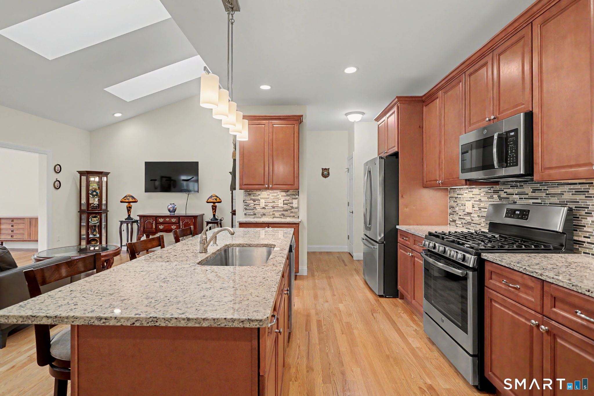 223 Meadow Brook Road, Unit 223 Oxford, CT 06478 - Photo 11 of 34 a kitchen with stainless steel appliances granite countertop a sink stove microwave and refrigerator