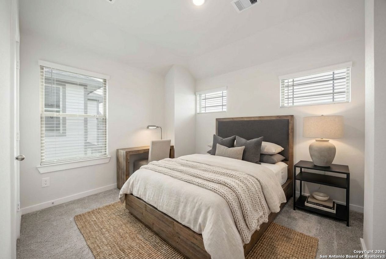 16447 Ginger Crossing Elmendorf, TX 78112 - Photo 6 of 6 a bedroom with a bed and wooden floor