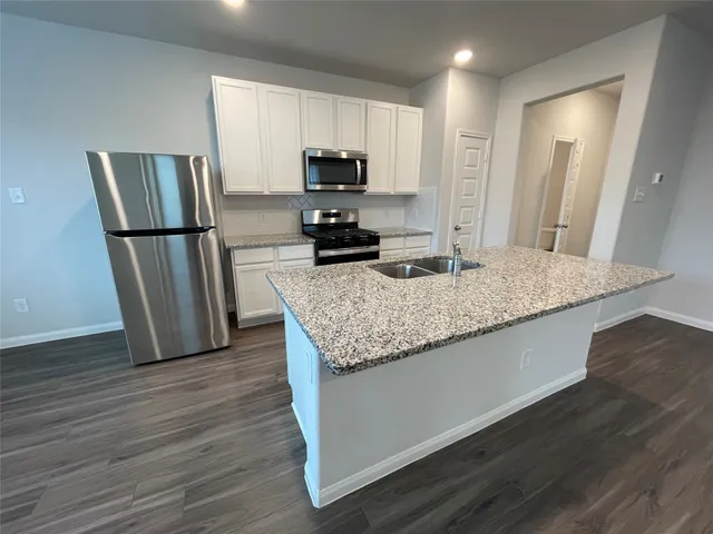 a view of kitchen with sink and wooden floor