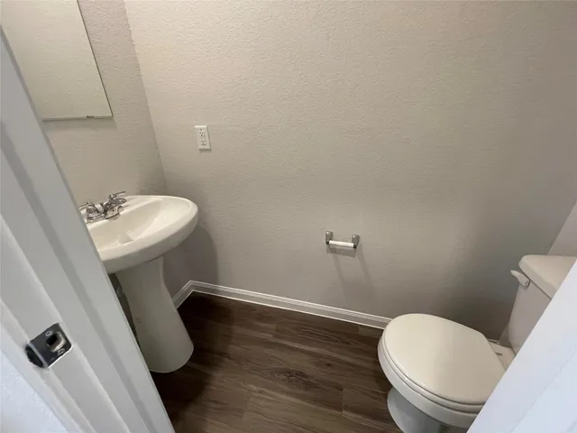 a kitchen with granite countertop sink stove and refrigerator