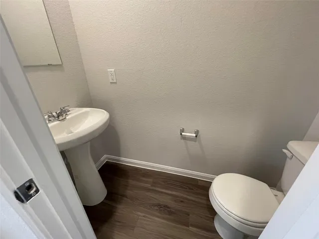 a kitchen with granite countertop sink stove and refrigerator