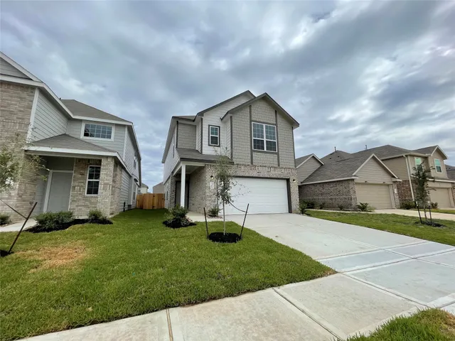 a view of a hallway with wooden floor and entryway