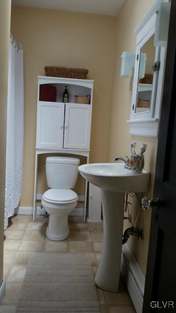 725 Spring Street Bethlehem, PA 18018 - Photo 14 of 21 a bathroom with a toilet sink and mirror