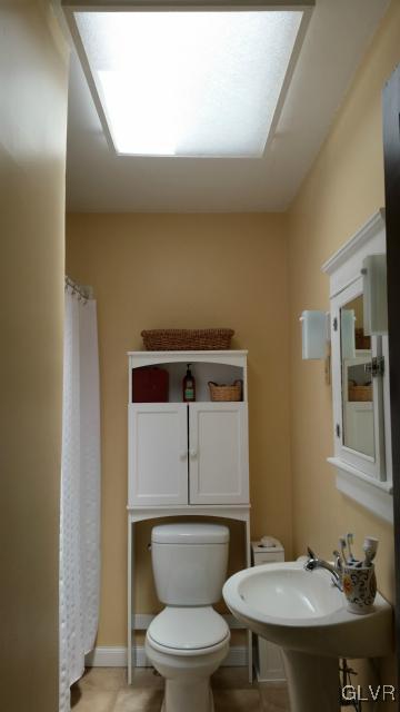 725 Spring Street Bethlehem, PA 18018 - Photo 15 of 21 a bathroom with a toilet a sink and mirror