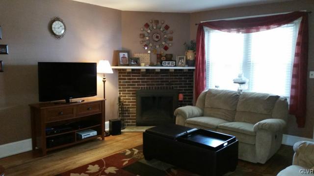 725 Spring Street Bethlehem, PA 18018 - Photo 3 of 21 a living room with furniture a flat screen tv and a fireplace