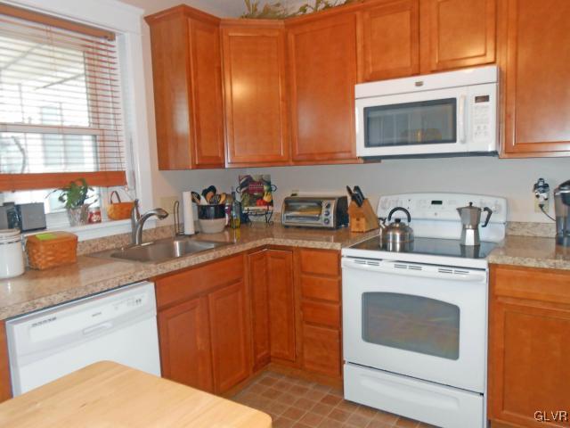725 Spring Street Bethlehem, PA 18018 - Photo 7 of 21 a kitchen with stainless steel appliances granite countertop a sink a stove and cabinets