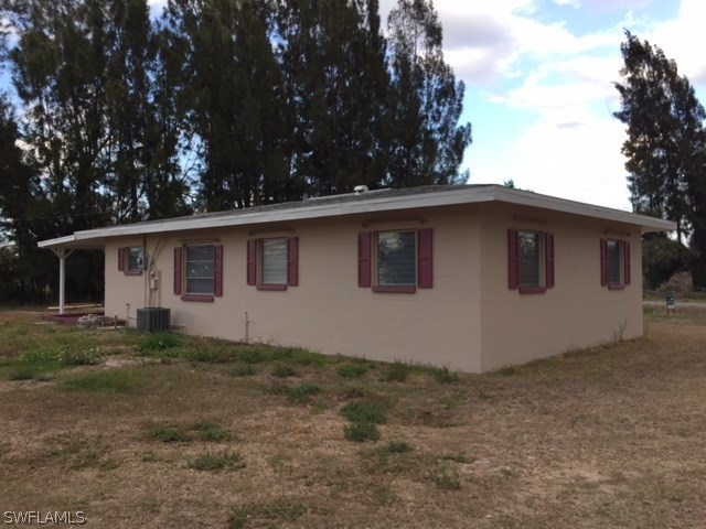 205 Delaware Road Lehigh Acres, FL 33936 - Photo 4 of 14 a view of a house with a yard