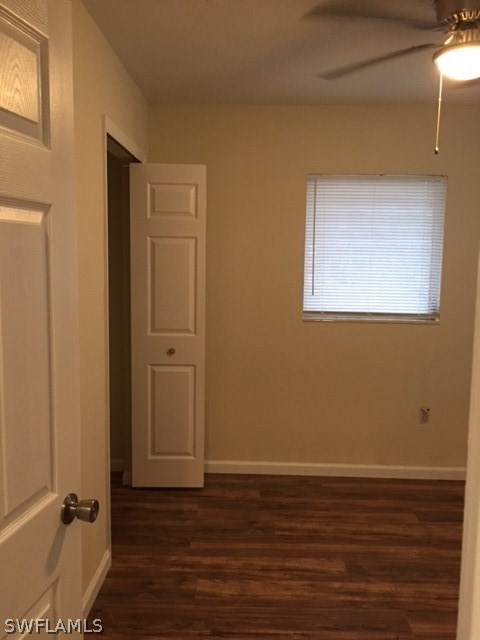 205 Delaware Road Lehigh Acres, FL 33936 - Photo 5 of 14 a view of a room with wooden floor and closet