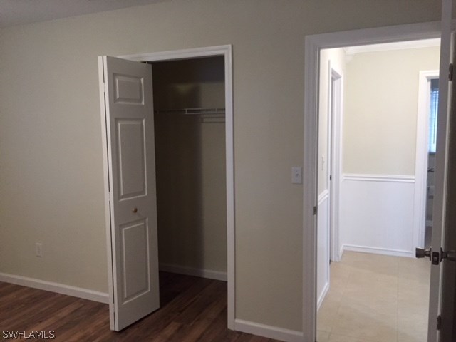 205 Delaware Road Lehigh Acres, FL 33936 - Photo 10 of 14 a view of a hallway with wooden floor